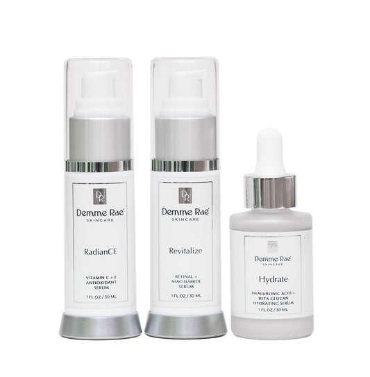 Three skincare products - RadianCE serum, Revitalize serum, and Hydrate serum - from Demne Rae on a white background